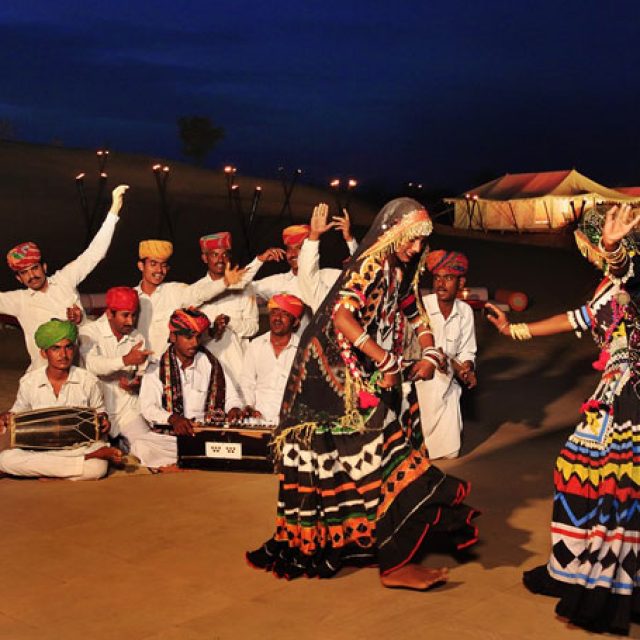 Attending traditional folk performances under the desert sky.