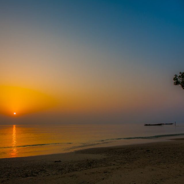 Enjoying a peaceful beach sunset at Radhanagar Beach.