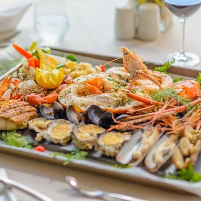 Enjoying fresh seafood and Creole cuisine by the beach.
